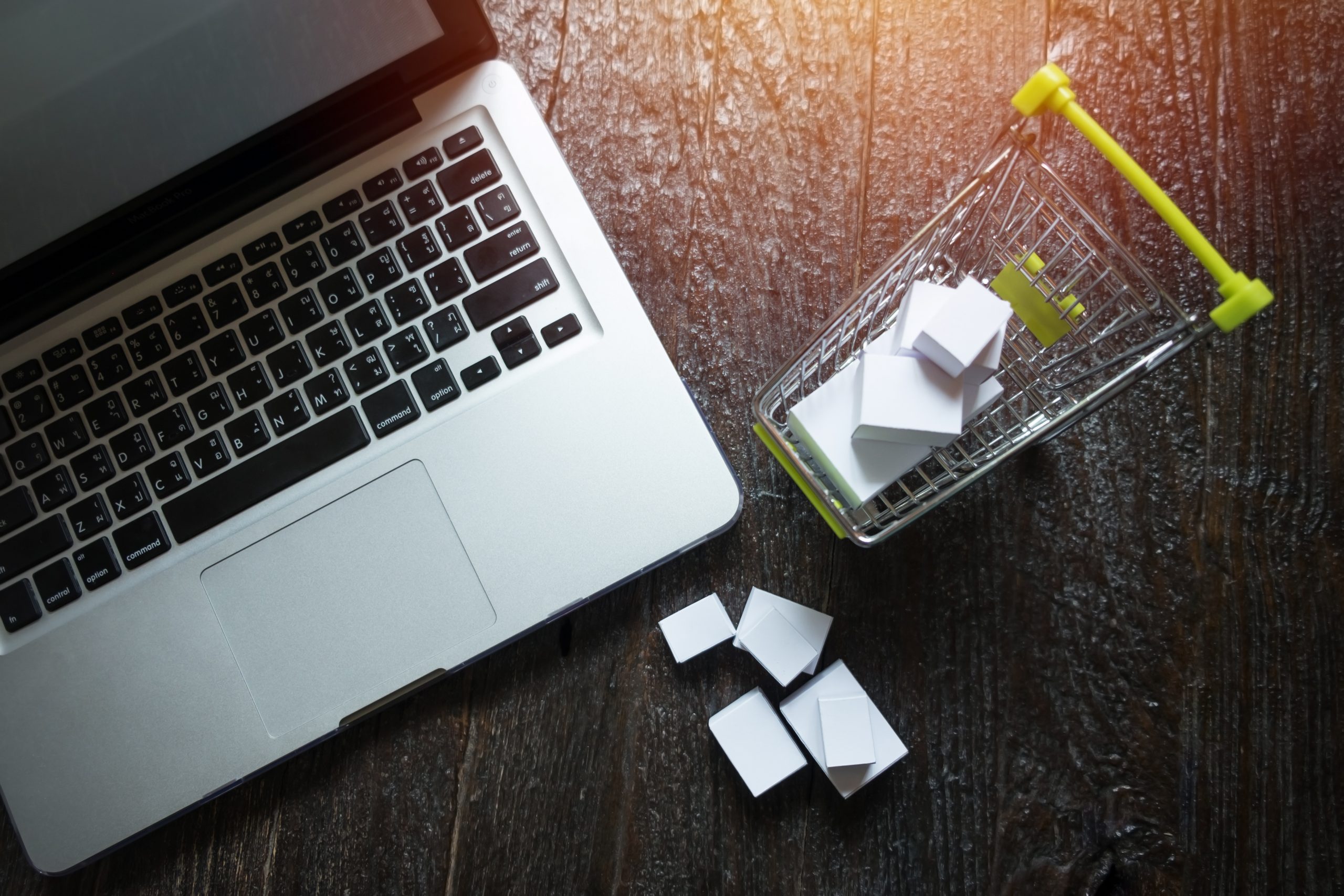 laptop blank screen and hopping cart full of gifts with copyspac